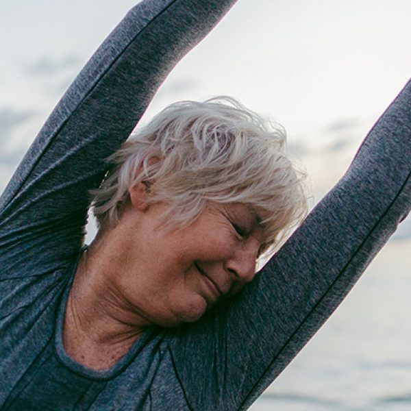 Lady stretching on beach web image