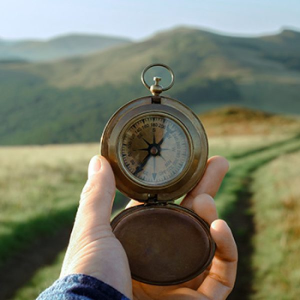 Website image - person holding a compass